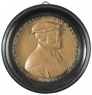 This medallion is a circular, post-medieval, boxwood medallion, the portrait being of Goedart van der Wier, believed to be a Dutch burgher, in profile to the right. The medallion is relatively large, at 2 7/8 in (7.2 cm) compared with the other medallions in the Bequest, but this diameter includes the frame. It is German, carved in Cologne in 1544 by Friedrich Hagenhauer. It is inscribed: M.GOEDART.VAN.DER.WIER WAS. 36 IAIR. ALT. 1542