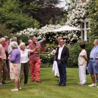 Biddy Marshal talks about the garden whilst EBTS UK members admire it